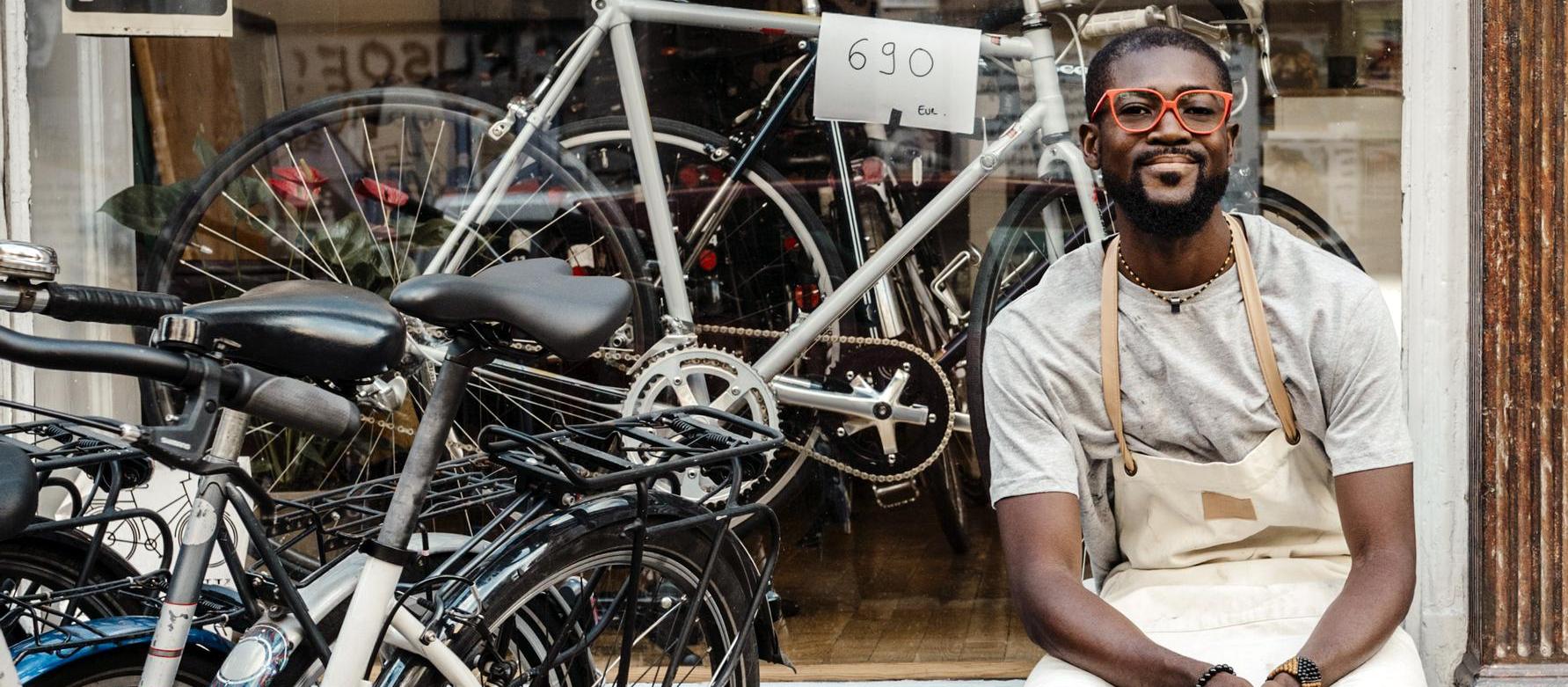 Business owner outside his bike shop